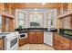 Charming kitchen featuring custom wood cabinets, granite counters, and stainless steel appliances at 917 Patrick Johnston Ln, Davidson, NC 28036