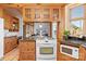 Kitchen view with wooden cabinets, granite countertops, and open access to the dining area at 917 Patrick Johnston Ln, Davidson, NC 28036