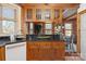 Kitchen area with wooden cabinetry, granite countertops, and open access to the dining area at 917 Patrick Johnston Ln, Davidson, NC 28036