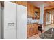 Kitchen area with stainless steel refrigerator, custom cabinets, and workstation desk at 917 Patrick Johnston Ln, Davidson, NC 28036