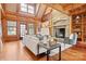 Cozy living room featuring a stone fireplace, wood beams, and comfortable seating arrangement at 917 Patrick Johnston Ln, Davidson, NC 28036