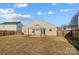 Large backyard with a covered patio and wooden fence at 9315 Ames Hollow Rd, Charlotte, NC 28216