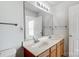 Double vanity bathroom with a large mirror and wood cabinets at 9315 Ames Hollow Rd, Charlotte, NC 28216