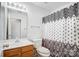 Bathroom with wood vanity, toilet and patterned shower curtain at 9315 Ames Hollow Rd, Charlotte, NC 28216