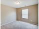 Well-lit bedroom featuring neutral walls and window blinds at 9315 Ames Hollow Rd, Charlotte, NC 28216