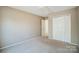 Bright bedroom with neutral walls, carpet, and double-door closet at 9315 Ames Hollow Rd, Charlotte, NC 28216