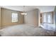 Bright dining room with a light-colored carpet and chandelier at 9315 Ames Hollow Rd, Charlotte, NC 28216