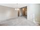 Simple dining room with carpet and access to the kitchen at 9315 Ames Hollow Rd, Charlotte, NC 28216