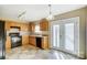 Kitchen with black appliances and wood cabinets and access to backyard at 9315 Ames Hollow Rd, Charlotte, NC 28216