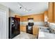 Kitchen with black appliances and wood cabinets at 9315 Ames Hollow Rd, Charlotte, NC 28216