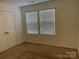 Empty bedroom with double doors and two windows at 9514 Currier Rd, Charlotte, NC 28215