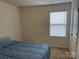 Simple bedroom with a double bed and window with blinds at 9514 Currier Rd, Charlotte, NC 28215