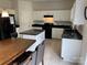 Kitchen with island, white cabinets, and granite counters at 9514 Currier Rd, Charlotte, NC 28215