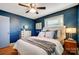 Bedroom with blue walls, hardwood floors, and ceiling fan at 9638 Pleasant View Ln, Mint Hill, NC 28227