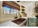 Copper farmhouse sink and modern fixtures in a newly updated kitchen at 9638 Pleasant View Ln, Mint Hill, NC 28227