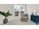 Neutral bedroom featuring a cozy chair, house plant, large window, and a lamp at 1012 Sweetleaf Dr, Indian Land, SC 29707