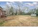 This backyard is a blank canvas with a shed for storage and mature trees at 108 White Oak St, Chester, SC 29706