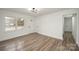 Bright, open-concept living room with modern light fixture and wood-look flooring, perfect for entertaining at 108 White Oak St, Chester, SC 29706