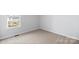 Well-lit bedroom featuring neutral wall colors and carpeting at 17 N Arlington St, Salisbury, NC 28144