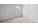 Bright bedroom with neutral carpeting and a backyard view at 17 N Arlington St, Salisbury, NC 28144