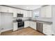 Modern kitchen with white cabinets and granite countertops at 17 N Arlington St, Salisbury, NC 28144