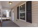 Covered porch with tan siding and black shutters at 17 N Arlington St, Salisbury, NC 28144