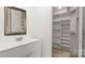 Bathroom vanity with mirror, lighting, and built-in closet at 2712 New Hamlin Way, Charlotte, NC 28210