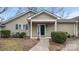 Charming home featuring an inviting entryway with a well-manicured lawn and complementary green door and shutters at 2712 New Hamlin Way, Charlotte, NC 28210