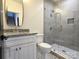 Modern bathroom with gray tile, glass shower, and updated vanity at 496 19Th Avenue Nw Cir, Hickory, NC 28601