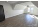Large bonus room with sloped ceilings, hardwood floors and two windows at 496 19Th Avenue Nw Cir, Hickory, NC 28601