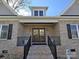 Front entry of charming brick home with double doors and black railings at 496 19Th Avenue Nw Cir, Hickory, NC 28601