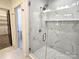 Walk-in shower with marble tile and pebble floor at 496 19Th Avenue Nw Cir, Hickory, NC 28601