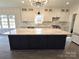 Spacious kitchen boasts a large island with white cabinets and marble countertops at 496 19Th Ave Nw Cir, Hickory, NC 28601