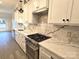 Modern kitchen with white cabinets, marble countertops, and stainless steel appliances at 496 19Th Avenue Nw Cir, Hickory, NC 28601
