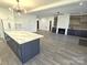 Open concept kitchen and living area with large island and fireplace at 496 19Th Avenue Nw Cir, Hickory, NC 28601