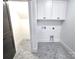 Convenient laundry room with upper cabinets and hexagon tile floor at 496 19Th Avenue Nw Cir, Hickory, NC 28601
