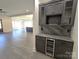 Built-in wet bar with wine cooler, granite countertop, and dark cabinetry at 496 19Th Avenue Nw Cir, Hickory, NC 28601