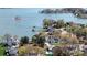 Expansive aerial view of lakeside home surrounded by lush greenery and waterfront access at 5056 Bridge Way, Denver, NC 28037