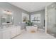 Luxurious bathroom with a soaking tub, walk-in shower, and modern vanity at 5056 Bridge Way, Denver, NC 28037