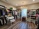 Walk-in closet with ample storage, custom shelving, and decorative chandelier at 5056 Bridge Way, Denver, NC 28037