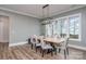 Spacious dining room with a long wooden table, lake view, and hardwood floors at 5056 Bridge Way, Denver, NC 28037