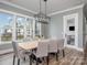 Bright dining room with a large wooden table and lake views at 5056 Bridge Way, Denver, NC 28037