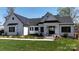 Charming modern farmhouse featuring white siding, black trim, and manicured lawn at 5056 Bridge Way, Denver, NC 28037