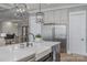 Modern kitchen features a large island, stainless steel appliances, and white cabinetry at 5056 Bridge Way, Denver, NC 28037