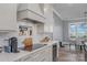 Modern kitchen with a gas cooktop, white cabinets, and a wine refrigerator at 5056 Bridge Way, Denver, NC 28037