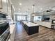 Spacious kitchen with modern island, pendant lighting, stainless appliances, and open living area at 5056 Bridge Way, Denver, NC 28037