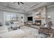 Spacious living room with a stone fireplace and lake views at 5056 Bridge Way, Denver, NC 28037