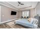 Main bedroom with a king-size bed, sitting area, and lake view at 5056 Bridge Way, Denver, NC 28037