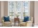 Cozy sitting area with two armchairs, a side table, and a lake view at 5056 Bridge Way, Denver, NC 28037