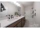 Modern bathroom features a double vanity, stylish fixtures, and a shower-tub combination at 5680 Clear Creek Ln, Charlotte, NC 28215